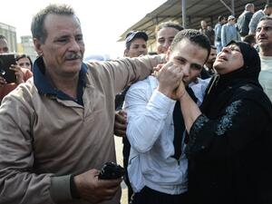 An Egyptian man embraces his parents following his release from prison in Cairo on March 14, 2017, along with 202 other prisoners who received a presidential pardon. (AFP/Aly Fahim)
