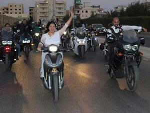 Hoda and Ahmed made their dreams come true by cruising around Cairo on scooters in their wedding attire before their big celebration. (Youm7)