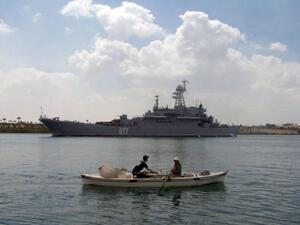 Egyptian fishermen row past a warship. (AFP/File) Egyptian fishermen row past a warship. (AFP/File)