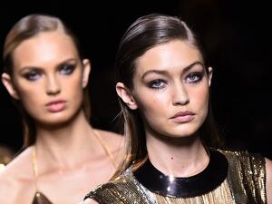 Gigi wore an asymmetric black sequinned gown and high heels as she led the other models to close the show. (AFP/Bertrand Guay)