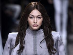 Gigi maintained her brunette locks while stepping out in Paris with Kendall after the show. (AFP/Martin Bureau)