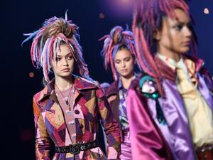 Each of the models wore their hair piled on top of their head, interwoven with faux-dreadlocks, dyed in an array of 300 shades. (AFP/Angela Weiss)