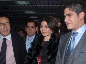 Haifa flanked by men, including husband Abu Hashima (R)