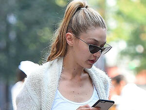 Gigi Hadid checks her phone. (Buzz Foto / Rex / Shutterstock)