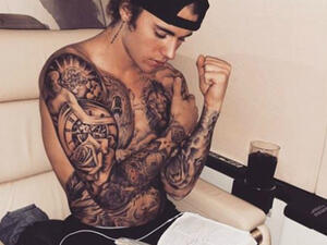 Justin made sure to show off his bulging biceps and almost fully tattooed torso in the snap as he appeared to be reading The Bible. (source: @justinbieber - Instagram)