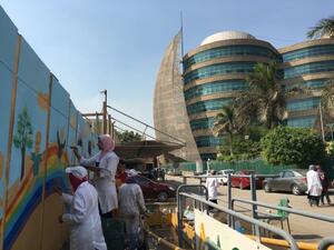 Students painting on the walls of the hospital.