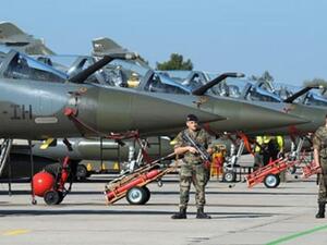 French soldiers are in faction in front of Mirages 2000 jets at the BA 133 air base in Nancy-Ochey, eastern France, on March 25, 2011. (AFP/Frederick Florin)