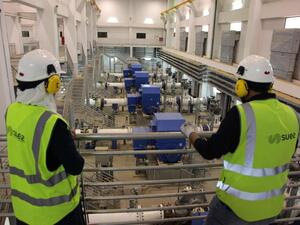 Workers look at the pumping station of the Disi water Project in Amman. (AFP)