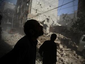 Locals examine the damage after airstrikes hit a rebel-controlled area of Douma, northeast of Damascus, on October 2, 2015.  (AFP/Abd Doumany)