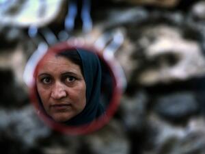A mirror shows the reflection of an Iraqi woman.  (AFP/File)