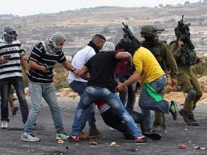 Members of Israeli security forces disguised as Palestinians fire bullets into a demonstration outside Ramallah on October 7, 2015.  (AFP/Abbas Momani)