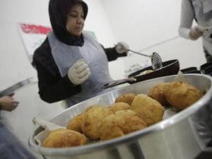 Syrian refugee women prepare traditional dishes in Beirut, Lebanon.  (AFP/Joseph Eid)