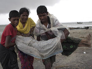 Rohingya Muslim refugees walk on the Bangladeshi shoreline of the Naf river (AFP/File Photo)	