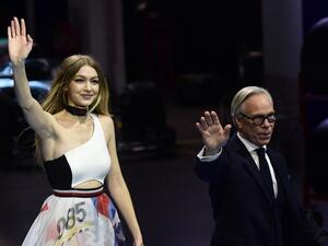 Gigi opened Sunday night’s show with a pair of blue and black leather racing leggings and a Hilfiger bandeau top, and closed in a long diaphanous layered maxi dress with racing logo prints. (Source: MIGUEL MEDINA - AFP)