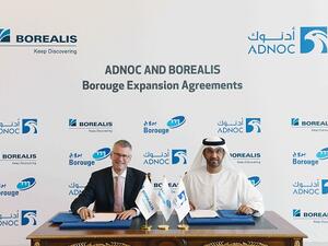 Dr. Sultan Al Jaber and Mark Garrett sign