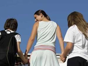 أم تقوم بإيصال أطفالها الى المدرسة