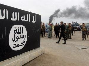 Bullet holes shown in an ISIS logo, AFP/File