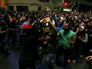 Jordanian riot police and security forces scuffle with protesters attempting to breach the area as they stand guard during a demonstration outside the Prime Minister's office in the capital Amman late on June 3, 2018. 
Khalil MAZRAAWI / AFP