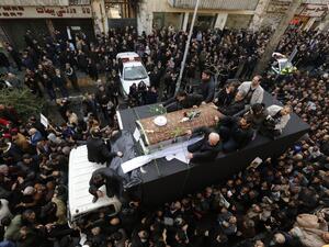 Iranians gather around a hearse carrying the coffin of former president Akbar Hashemi Rafsanjani during his funeral ceremony in the capital Tehran, on January 10, 2017. (AFP/Atta Kenare)