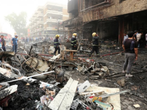 Emergency responders and civilians react to the scene of a car bomb in Baghdad's Karrada district on July 3, 2016. (AFP/File)