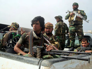 Members of Iraq's Popular Mobilization Units drive into Tikrit, Iraq in 2015. (AFP/File)