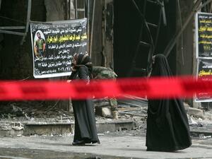 Iraqi women walk past the site of Sunday's bombing, marked off with red tape. (AFP/Sabah Arar) Iraqi women walk past the site of Sunday's bombing, marked off with red tape. (AFP/Sabah Arar)