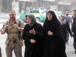 The mother (2nd L) of 16-year-old Iraqi Nabil Abdul Karim, who died in a massive bombing in Baghdad's Karada neighborhood as he went to celebrate his birthday, reacts as she visits the aftermath of the attack on July 4, 2016. (AFP/Sabah Arar)