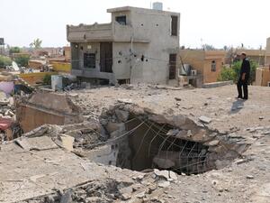 An Iraqi man stands on top of a damaged building on October 27, 2016, a few days after an air strike hit a Shia place of worship in the Iraqi town of Daquq, south of Kirkuk. (AFP/Marwan Ibrahim)