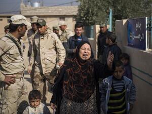 An Iraqi woman who had fled the fighting is pleading with the soldiers as her son is being questioned by the Iraqi army 9th armoured division at an operating base adjacent to the Al-Intissar neighbourhood of Mosul on November 7, 2016. (AFP/Odd Andersen)