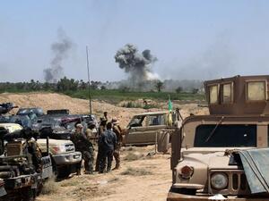 Iraqi government forces advance near al-Sejar village, north-east of Fallujah, as smoke billows in the background on May 26, 2016, as they take part in a major assault to retake the city from the Islamic State (IS) group. (AFP/Ahmad al-Rubaye)