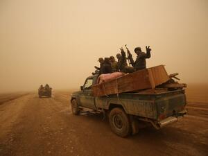 Shia fighters from the Hashed al-Shaabi (Popular Mobilization) paramilitaries drive through a desert area near the village of Al-Boutha al-Sharqiyah, west of Mosul, on December 2, 2016. (AFP/Ahmad al-Rubaye)