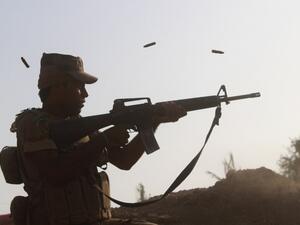 A member of the Iraqi pro-governement forces fires his weapon on a front line in the Albu Huwa area, south of Fallujah near the Euphrates river, on June 1, 2016, during an operation aimed at retaking areas from the Islamic State group. (AFP/Moadh al-Dulaimi)