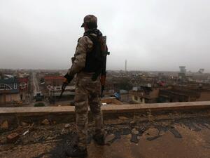 An Iraqi security member stands guard as Iraqi Christians attend a Christmas Eve service at the Saint John's church in the town of Qaraqosh, 30 km east of Mosul, on December 25, 2016. (AFP/Safin Hamed)