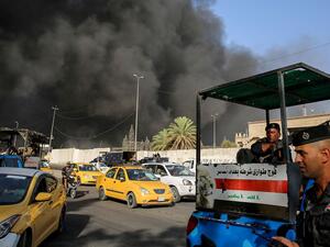 Members of the Iraqi federal police outside a ballot warehouse in Baghdad caught on fire. (AFP/ File)