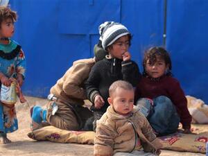 Displaced Iraqi children sit at the al-Agha camp near the city of Tal Afar, southwest of the Iraqi city of Mosul, February 16, 2017. (AFP)