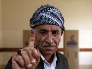 An Iraqi Kurdish man shows his ink-stained finger after voting in the Kurdish independence referendum in Arbil. (AFP/ File Photo)