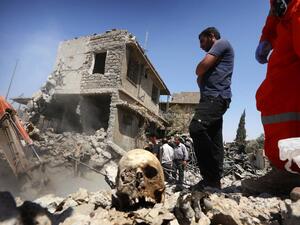 Iraqi civil defense and rescue workers search for the bodies of victims under the rubble of buildings in western Mosul's Zanjili district on July 26, 2017 (Safin Hamed/AFP)