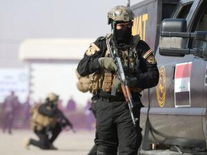 Iraqi SWAT policemen show their skills during a ceremony to mark the 95th anniversary of the creation of the Iraqi police at the Shaabiyah training camp in the southern city of Basra on January 9, 2017. (AFP/Haidar Mohammed Ali)