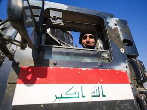 A member of the Iraqi security forces poses from inside an armored vehicle in the village of al-Buseif, south of Mosul, during an offensive by Iraqi forces to retake the western side of the city from Daesh on February 22, 2017. (AFP/Ahmad al-Rubaye)