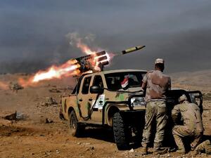 Members of the Iraqi army's 9th Division fire a multiple rocket launcher from a hill in Talul al-Atshana, on the southwestern outskirts of Mosul, on February 27, 2017. (AFP/Aris Messinis)