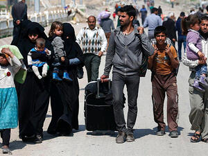 Residents flee their homes in the Old City. Some are not so lucky – one witness says he cannot leave his home for fear of being shot by militants. (AFP)