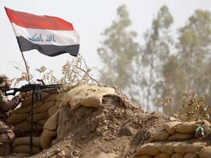An Iraqi militia fighter holds a post in Salahudin province (AFP/Mohammad Sawaf)
