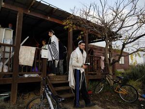 An Israeli settler prays in the settlement outpost of Amona, which was established in 1997 and built on private Palestinian land, in the Israeli-occupied West Bank on December 18, 2016. (AFP/Menahem Kahana)