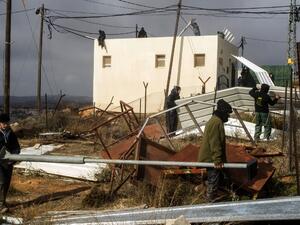 Israeli youth settlers block the entrance of the settlement outpost of Amona on December 15, 2016, which was established in 1997, in the Israeli-occupied West Bank. (AFP/Jack Guez)