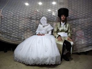A Jewish bride sits next to her groom during the Mitzvah Tans dance ritual following their wedding in an ultra-orthodox neighbourhood in Jerusalem. (AFP/File)  