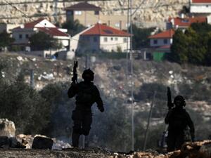 Israeli security forces take position near the settlement of Kadumim during clashes following a demonstration against the expropriation of Palestinian land by Israel in the village of Kfar Qaddum, in the occupied West Bank, on December 23, 2016. (AFP/Jaafar Ashtiyeh)