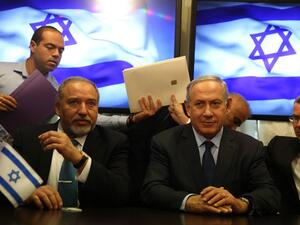 Israeli Prime Minister Benjamin Netanyahu and Avigdor Lieberman, the head of hardline nationalist party Israel Beiteinu, are seen during a ceremony signing a coalition agreement on May 25, 2016 at the Knesset. (AFP/Menahem Kahana)