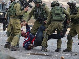 Israeli soldiers detain a Palestinian stone thrower near Beit El, on outskirts of the West Bank city of Ramallah. (AFP/ File Photo)