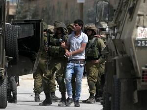 Israeli soldiers arrest Palestinian demonstrators amid clashes in the West Bank village of Beita, southeast of Nablus city, after a protest took place following Friday prayers in solidarity with Palestinian prisoners on hunger strike in Israeli jails, on April 21, 2017. (AFP/Jaafar Ashtiyeh)