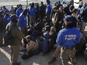 Israeli police guard Israeli settlers on the second day of an Israeli police operation to evict the hardline occupants and their supporters from the West Bank settler outpost of Amona on February 2, 2017. (AFP/Thomas Coex)